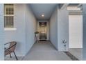 Light and airy entryway with dark front door and tile flooring at 7332 S Briarwood Ln, Gilbert, AZ 85298