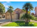 Two-story house with palm trees and a well-maintained lawn at 8947 E Mescal St, Scottsdale, AZ 85260