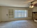 Living room with built-in shelving and window at 914 N 40Th Ave, Phoenix, AZ 85009