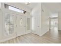 Bright foyer features a tiled floor, large transom window, and a white door with decorative glass at 9230 N 104Th Pl, Scottsdale, AZ 85258