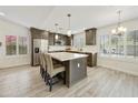 Bright kitchen featuring stainless steel appliances, grey cabinets, a large island, and plantation shutters at 9230 N 104Th Pl, Scottsdale, AZ 85258