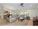 Spacious living room with L-shaped sofa and hardwood floors at 9230 N 104Th Pl, Scottsdale, AZ 85258