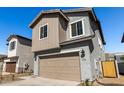 View of a gray two-story home with a two-car garage and desert landscaping at 9350 E Sequence Ave, Mesa, AZ 85212