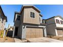 Shot of two-story home featuring attached two-car garage and desert landscaping at 9350 E Sequence Ave, Mesa, AZ 85212