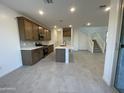 Modern kitchen featuring an island and dark brown cabinetry at 9350 E Sequence Ave, Mesa, AZ 85212