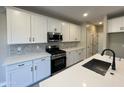 Modern kitchen with white cabinets, stainless steel appliances, and quartz countertops at 9358 E Sequence Ave, Mesa, AZ 85212