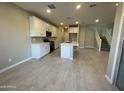 Modern kitchen featuring white cabinets, center island, and tile floors at 9358 E Sequence Ave, Mesa, AZ 85212