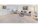 Living room with couch and recliner, offering a relaxing atmosphere at 10429 W Roundelay Cir, Sun City, AZ 85351