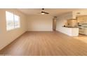 Spacious living room featuring light wood floors and kitchen access at 14806 N Yerba Buena Way # D, Fountain Hills, AZ 85268