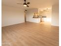 Open living room with light wood floors and kitchen view at 14806 N Yerba Buena Way # D, Fountain Hills, AZ 85268