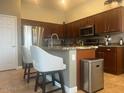 Kitchen boasts a large island with seating and stainless steel appliances at 18176 W Paradise Ln, Surprise, AZ 85388