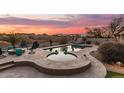 Spacious backyard oasis with a sparkling pool, spa, and fire pit at 18193 W Buckhorn Dr, Goodyear, AZ 85338