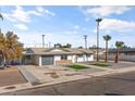 Updated mid-century home, freshly painted, with a new garage door and landscaping at 1890 E Palmcroft Dr, Tempe, AZ 85282