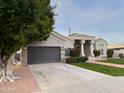 House exterior featuring a two-car garage and manicured lawn at 2332 E Nora St, Mesa, AZ 85213
