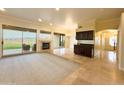 Spacious living area with fireplace, large windows, and access to a patio at 2332 E Nora St, Mesa, AZ 85213