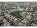 An aerial view of a beautiful community with tree-lined streets and lakes at 2338 N 112Th Ln, Avondale, AZ 85392