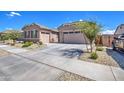 Two-car garage, desert landscaping, and curb appeal at 24393 N 169Th Dr, Surprise, AZ 85387