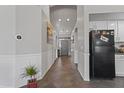 Hallway with tile flooring and view into living room at 25671 W Miami St, Buckeye, AZ 85326