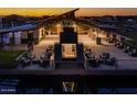 Night view of a community clubhouse with a large fire pit and seating area at 26128 S 228Th Pl, Queen Creek, AZ 85142
