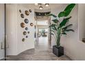 Bright and spacious entryway with tile flooring and modern wall art at 3021 W Feather Sound Dr, Phoenix, AZ 85086