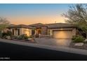 Stunning curb appeal featuring a two-story home with desert landscaping and a large driveway at 3021 W Feather Sound Dr, Phoenix, AZ 85086