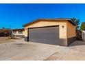 Attached two-car garage with a dark gray door at 3726 W Coolidge St, Phoenix, AZ 85019