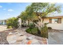 Inviting home exterior with mature shade trees and stone walkway at 4301 E Montecito Ave, Phoenix, AZ 85018
