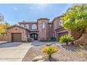 Beautiful two-story home with stone accents and a three-car garage at 4543 S Roy Rogers Way, Gilbert, AZ 85297