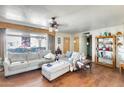Cozy living room with hard wood floors, a ceiling fan, and a large window at 5501 E Dallas St, Mesa, AZ 85205