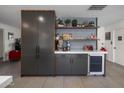 Sleek kitchen with dark cabinetry, open shelving, and a built-in wine cooler at 5820 N 83Rd St, Scottsdale, AZ 85250