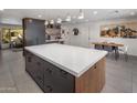 Modern kitchen with a large island, dark cabinetry, and quartz countertops at 5820 N 83Rd St, Scottsdale, AZ 85250