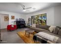 Bright living room with large window, comfortable seating, and a piano at 5820 N 83Rd St, Scottsdale, AZ 85250