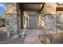 Elegant entryway with stone accents and a charming decorative goose statue at 6102 E Sonoran Trl, Scottsdale, AZ 85266