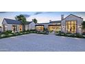 Elegant home with a stone facade, landscaped grounds and a paved driveway at 6109 E Maverick Rd, Paradise Valley, AZ 85253