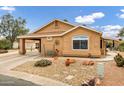 Tan one-story house with a covered carport and landscaped yard at 6892 S Lake Forest Ct, Chandler, AZ 85249