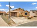 Tan one-story house with a covered carport and landscaped yard at 6892 S Lake Forest Ct, Chandler, AZ 85249
