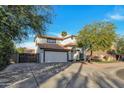 Two-story house with white exterior, attached garage, and gated driveway at 1126 E San Remo Ave, Gilbert, AZ 85234