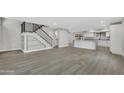 Open living room with gray flooring, a kitchen island, and built-in shelving at 1126 E San Remo Ave, Gilbert, AZ 85234