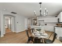 Modern kitchen with white cabinets, island, and dining area at 12838 N 148Th Ln, Surprise, AZ 85379