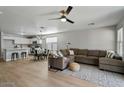 Spacious living room with L-shaped sectional sofa and hardwood floors at 12838 N 148Th Ln, Surprise, AZ 85379