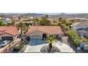 House with tile roof, palm trees, and a long driveway in a neighborhood at 15429 E Palomino Blvd, Fountain Hills, AZ 85268