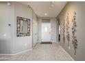 Bright and airy entryway with tile flooring and decorative wall art at 15725 W Linksview Dr, Surprise, AZ 85374