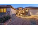 Stone and stucco exterior with a curved walkway leading to the entryway at 15725 W Linksview Dr, Surprise, AZ 85374