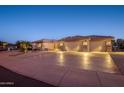 Well-maintained property with a large driveway and desert landscaping at 15725 W Linksview Dr, Surprise, AZ 85374