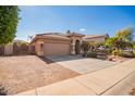 House exterior with a two-car garage and a pathway leading to the entrance at 15839 W Calavar Rd, Surprise, AZ 85379