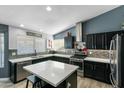 Beautiful kitchen featuring dark wood cabinets, an island with seating, stainless appliances, and stylish backsplash at 16241 S 40Th Way, Phoenix, AZ 85048