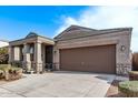 Single story house with a two car garage and stone accents at 1631 N Beverly --, Mesa, AZ 85201