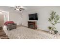 Living room with brown couch, electric fireplace, and patterned rug at 16420 N Scorpion Dr, Fountain Hills, AZ 85268