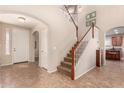 Two-story entryway with a staircase and tile floors at 17584 W Andora St, Surprise, AZ 85388