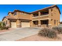 Two-story house with a three-car garage and a large driveway at 17584 W Andora St, Surprise, AZ 85388